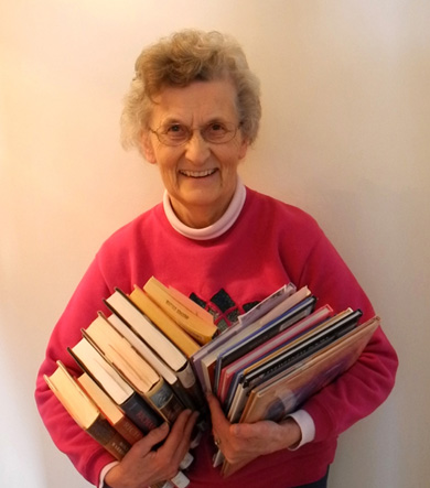 Holding an armful of library books